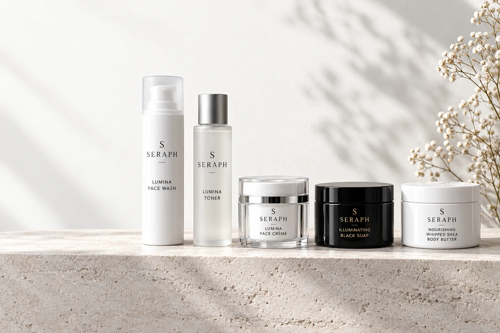 The Seraph collection: Lumina Face Wash, Toner and Face Crème, Illuminating Black Soap and Whipped Shea Body Butter on travertine